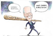 Joe Biden carries a large wooden club inscribed with "democracy" with two speech bubbles reading "Speak softly.. and carry a big stick!"